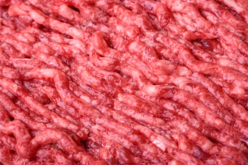 Preview: Raw ground beef or pork on a wooden cutting board with spices and salt