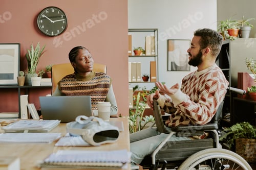 Preview: Coworkers Chatting during Break in Office