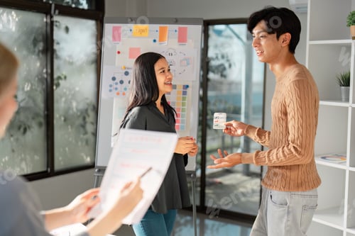 Preview: UX UI designer presenting ideas to a client with visuals in a bright office.