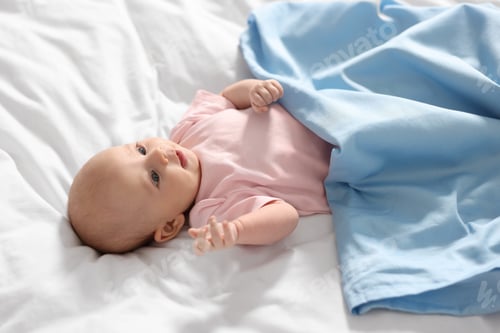 Preview: Cute little baby lying on white sheets