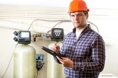 Preview: male worker inspecting work of industrial equipment