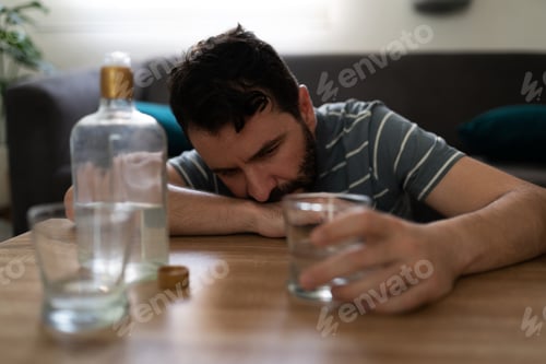 Preview: Man with depression drinking alcohol in his home