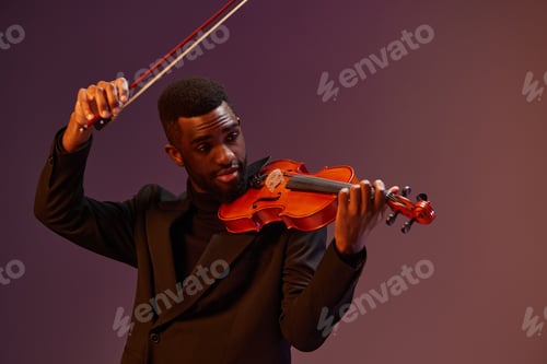 Preview: Elegant African American man in black suit playing violin on vibrant purple background