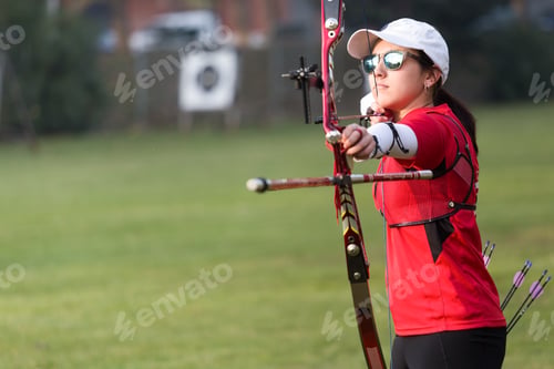 Preview: Female athlete practicing archery in stadium