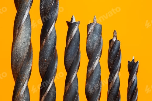 Preview: Drills for wood of different sizes for a drill on an orange background. Construction tool