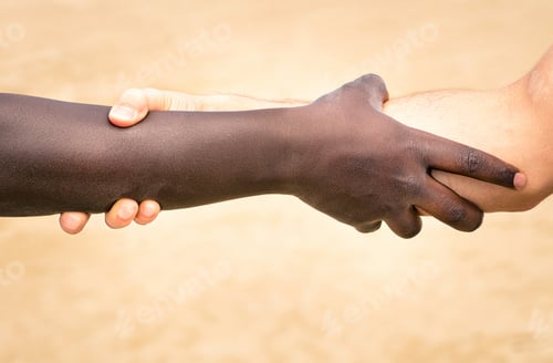 Preview: Black and white hands in modern handshake to show each other friendship and respect