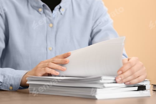 Preview: Woman working with documents at table in office, closeup