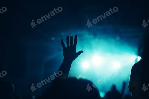 Preview: Female hand raised in the air on rock music concert