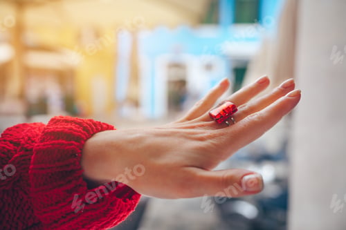 Preview: Female hand with a red ring