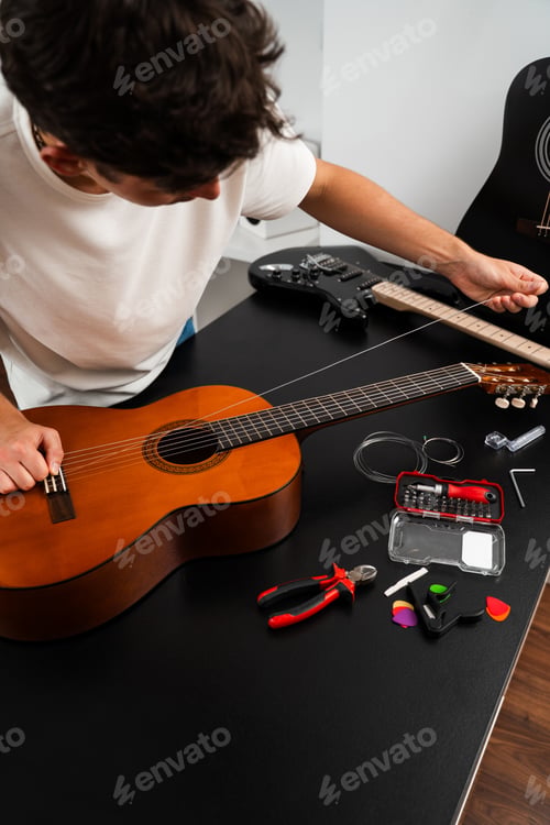 Preview: Guitarist replacing worn strings with new ones on acoustic guitar