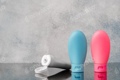 Preview: Blue and Pink Plastic Bottles on Grey Background