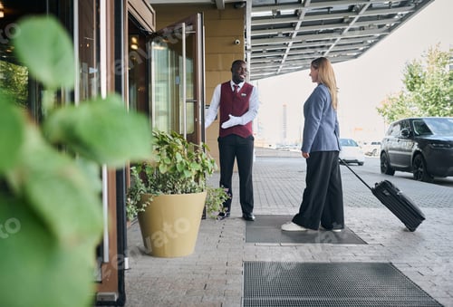 Preview: Doorman of the hotel meeting the guest