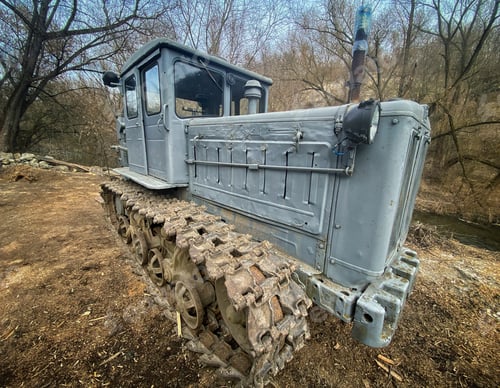 Preview: old caterpillar tractor in the forest by the river. swamp walker