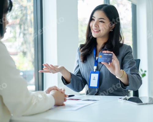 Preview: Asian business customer service representatives work and smile serve sell credit card to customers