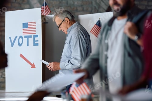 Preview: Senior US citizen at voting booth at polling station.
