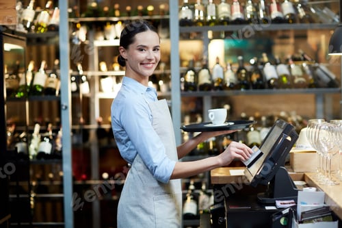 Smiling Waitress Handles Payment in Restaurant Workplace