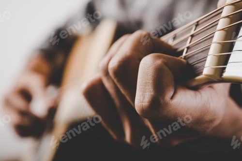 Preview: Close up of man hand playing guitar.