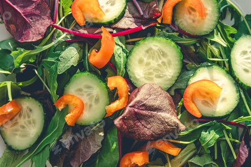 Preview: Close-up, salad with fresh cucumbers, peppers and arugula.