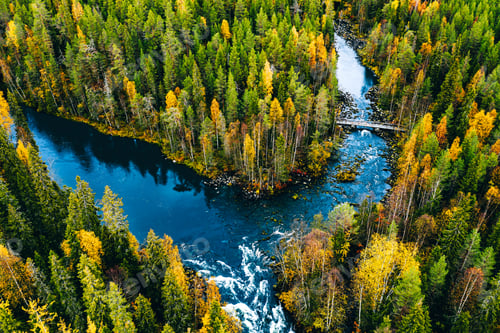 Preview: Aerial view of fast river flow through the rocks and colorful forest. Autumn in Finland