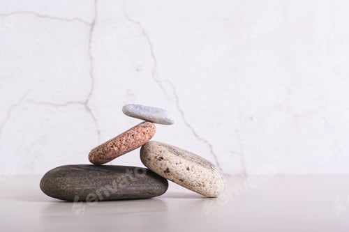 Preview: Balancing structure made of smooth sea stones on a table