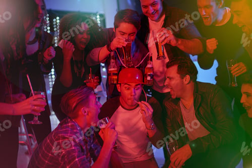 Preview: Have a drink on us. Cropped shot of a group of friends drinking and having fun at a party.