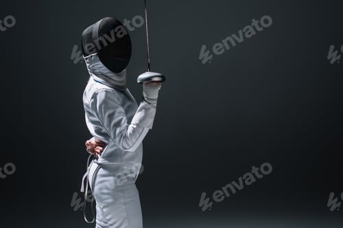 Preview: Side view of fencer holding rapier isolated on black with copy space