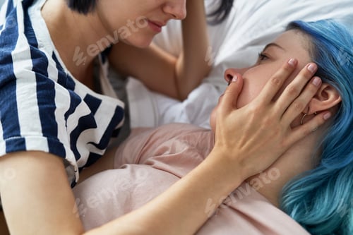Preview: Close up of romantic lesbian couple lying on bed