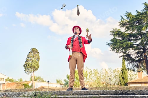 Preview: Man juggling clubs on steps