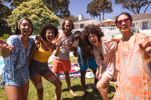 Preview: Diverse group of friends having fun and smiling at a pool party