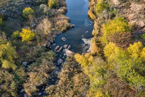 Preview: A picturesque stream flows in the Aktovsky Canyon, surrounded by autumn trees and large stone