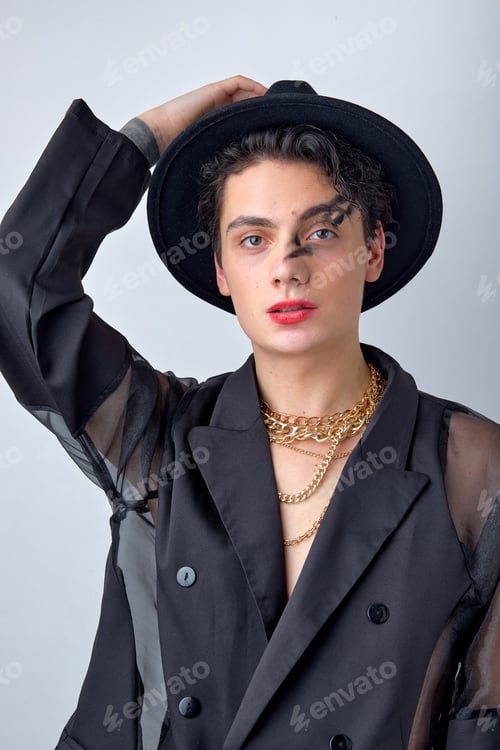 Preview: Male makeup look. Portrait of sexy brunette man in black stylish wear, posing