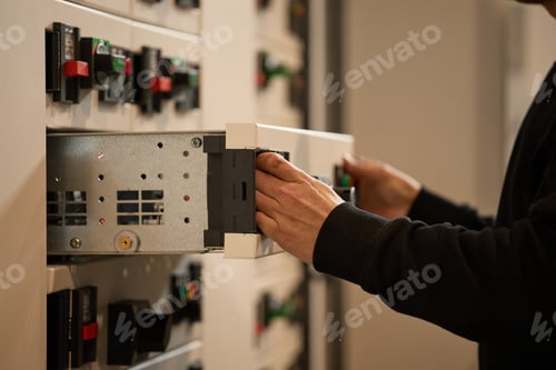 Preview: Person Handling Electrical Equipment in a Professional Setting for Maintenance or Installation