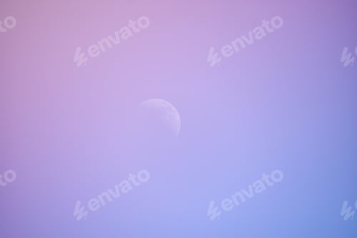 Preview: Purple sky with a blurred moon during a bright sunset