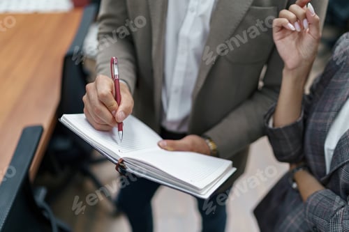 Preview: Close up of Businessman standing in office and making notes