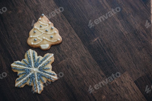 Preview: Two decorated cookies on a dark wooden table. #debb_a/Christmas, #debb_a/food,