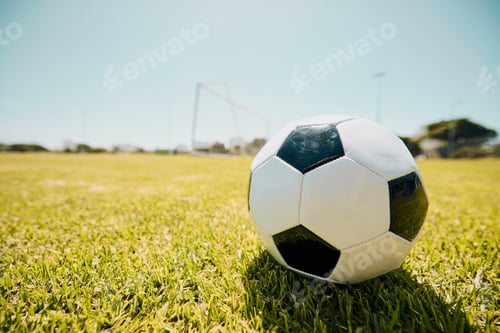 Preview: Soccer, sports and fitness with a ball on a grass pitch or field ready to a game or match outdoor d