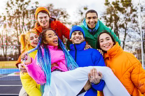 Preview: Multiracial group of young friends meeting outdoors in winter