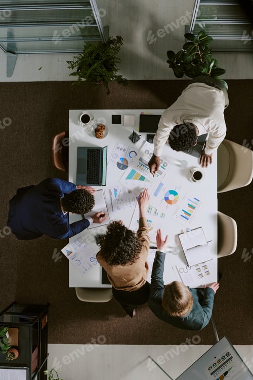 Preview: Collaborating Team Analyzing Business Data and Charts