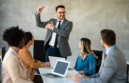 Preview: Multicultural professional businesspeople working together on research plan in boardroom.