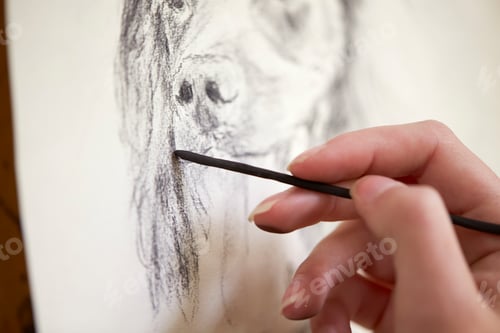 Preview: Close Up Of Artist Sitting At Easel Drawing Picture Of Dog In Charcoal