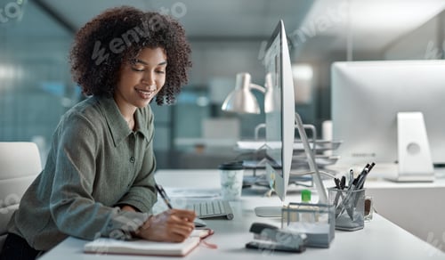 Preview: Shot of a young female agent working in a call centre smiling while taking notes