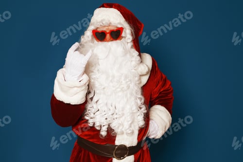Preview: Authentic Santa Claus wearing sunglasses on blue background