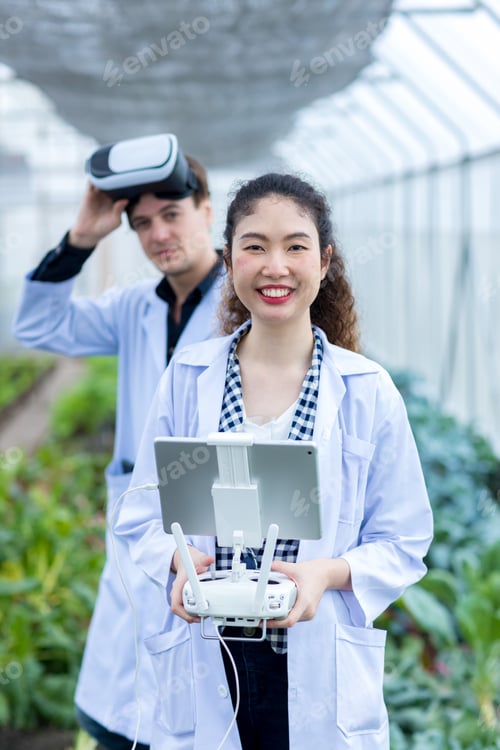Preview: Scientist use remote controller piloting drone at vegetable garden Lab