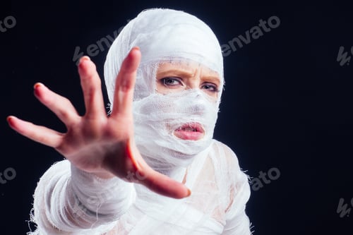 Preview: Glamorous mummy woman in bandages all over her body studio black background