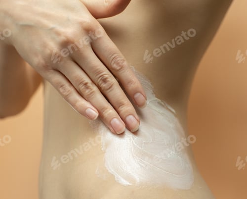 Preview: woman hand put moisturizing cream on body skin