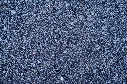 Preview: Gray pebbles as a background. Round stones on the beach. Photography for design.