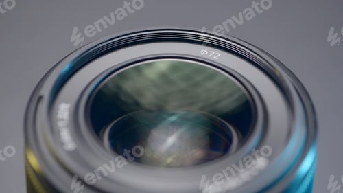 Preview: Close up of a new camera lens on blurred grey background. Action. Details of professional