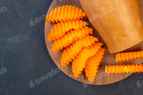 Preview: top half view butternut squash slices on wood board on table