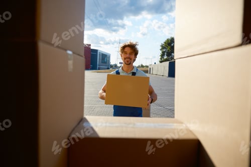 Preview: Young warehouse worker holding clipboard box unloading delivery truck car