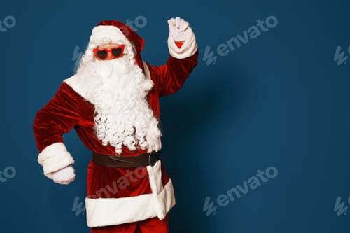 Preview: Authentic Santa Claus wearing sunglasses on blue background. Space for text
